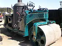 United States-built 1924 Buffalo Springfield steam roller: a vertical boiler design with tandem rolls. Note position of firebox door, facing out of frames.