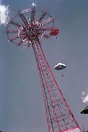 The Parachute Jump at the World's Fair in 1939 or 1940. Riders in parachutes can be seen descending from the top of the structure.