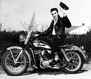 Singer Elvis Presley sitting on a motorcycle