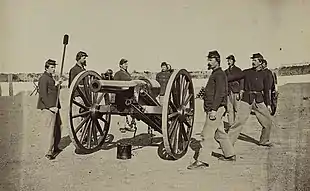 Sepia photo shows a Civil War era USA gun crew practicing with a 20-pounder Parrott rifled gun.