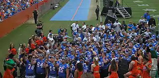 Players and cheerleaders standing together after a game