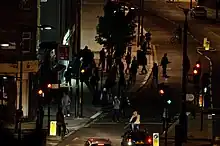 Looters attempting to enter a cycle shop in North London during the 2011 England riots