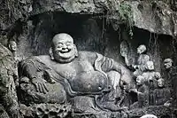 Rock carving of Budai in the grottoes