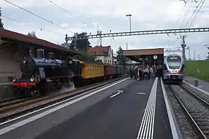 Steam locomotive and modern electric train at Degersheim
