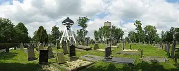 The graveyard and belfry in Nes in 2014, with in the background the Water Tower of Akkrum.