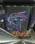 Artwork depicting Ramses Shaffy over the southern escalators