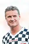 David Coulthard wearing a black and white checkered football kit
