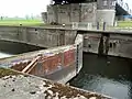 Old canal lock in the canal under the bridge