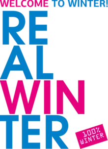 Text of the three slogans of the 2019 Winter Universiade in the graphic standard of the games: a semi-bold, sans serif typeface used in bright fuchsia (pink) and icy blue. At the top, the alternate slogan "Welcome to Winter!" is printed on a single line with the word "Welcome" in fuchsia and "to Winter!" in blue. Directly below, the primary slogan "Real Winter" is vertically aligned in four rows along the left side, reading RE – AL – WIN – TER; "WIN" is printed in fuchsia and the remaining text in blue. In the lower right corner, a fuchsia rectangle is set on a 30-degree angle with left-aligned text reading "100% Winter" in a white, typewriter-style serif typeface is printed on two lines.