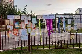 "Wall of shame" near a school with diplomas issued by the school, graduate sashes and protest inscriptions. Such installations were made in protest against presumable falsifications by the teachers
