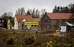 Lützerath in 2021, a squatted farm with a banner