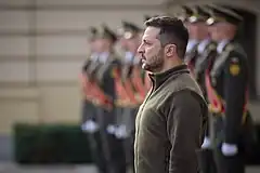 Volodymyr Zelenskyy standing next to Ukrainian soldiers in dress uniform in front of Mariyinsky Palace in Kyiv