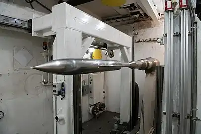 An AGARD-B model installed on a sting is shown in the tank below Supersonic Wind Tunnel A in the von Kármán Gas Dynamics Facility