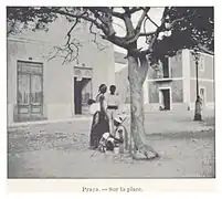 Photo of three people and a baby under a tree