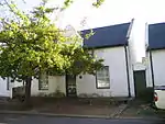 These properties were granted in 1750 to the landdrost and Heemrade, and to Jan Greyling. The complex of buildings is of special architectural interest and forms an essential part of the historic core of Stellenbosch.