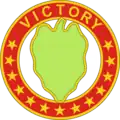 A hollow red circle with stars and the word "Victory", inside a green leaf