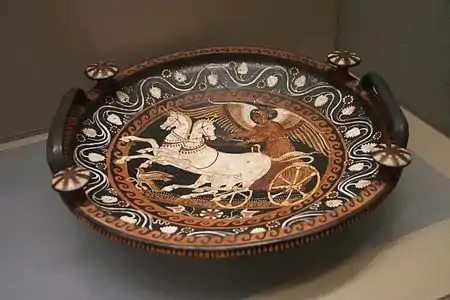The goddess Nike riding on a two-horse chariot on an Apulian patera (tray), 4th century BC
