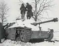 Engineers from the 291st disarm a booby-trapped Sturmgeschütz III during the Battle of the Bulge