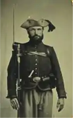 old picture of oddly dressed American Civil War soldier with three-cornered hat, baggy pants, and unusual shirt