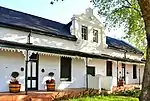 These two Victorianised houses, which were originally erected during the first half of the 19th century, together with six other similar buildings, form one of the most charming and harmonious street scenes in Stellenbosch.