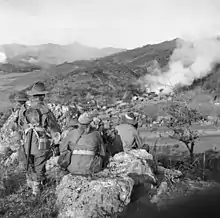 Image 69Soldiers from 3 RAR watch as a Korean village burns in late 1950 (from History of the Australian Army)