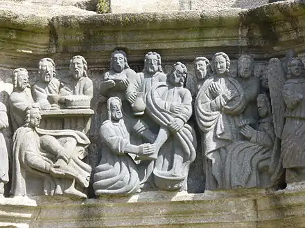 Jesus washing the disciples' feet. Note that the disciple sitting on the far left is taking off his shoes ready to take his turn.