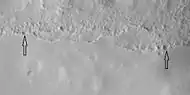 Close view of mantle, as seen by HiRISE under HiWish program Arrows show craters along edge which highlight the thickness of mantle.  Mantle may be used as a water source by future colonists.  Location is Ismenius Lacus quadrangle.