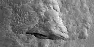 Close view of depression, as seen by HiRISE under HiWish program  Straight, steep wall near the bottom faces the north pole.