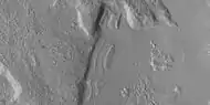 Close view of dipping layers along a mesa wall, as seen by HiRISE under HiWish program  Location is Ismenius Lacus quadrangle.