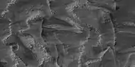 Layers breaking up into boulders in Galle Crater, as seen by HiRISE under HiWish program