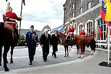 Members of the regiment's mounted troop (on horseback) providing a guard for US Defence Secretary Robert Gates in Banff.