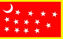 Red flag with a yellow border and a central design of thirteen white stars and a white crescent moon