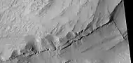 Close view of layers, as seen by HiRISE under HiWish program   A ridge cuts across the layers at a right angle.