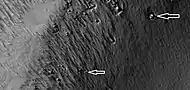 Close view of boulders sitting in pits,  as seen by HiRISE under HiWish program