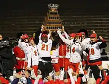 The Calgary Dinos hoist the Vanier Cup trophy following their win over the Montreal Carabins in 2019.