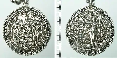 Both sides of an ornate silver medal