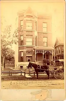 This is an 1880s photo of 653 W Wrightwood (now 655 W Wrightwood) in Lincoln Park, Chicago, Illinois. Note the wooden sidewalk, dirt road and lack of buildings surrounding the edifice.