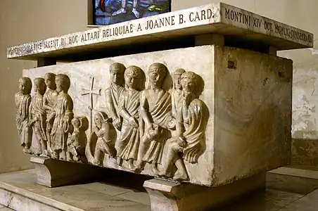 Photograph of a stone sarcophagus with several figures in high relief.