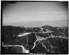 Aerial view of former Nike missile site near Los Angeles, showing radar site in upper left and launch site in foreground. By Everett Weinreb for HAER (April 1988).