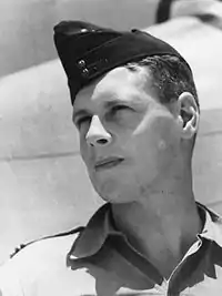 Portrait of Wilfred Arthur in forage cap and open collared shirt