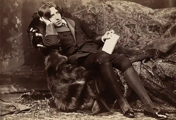 Image 17Oscar Wilde reclining with Poems, by Napoleon Sarony, in New York in 1882. Wilde often liked to appear idle, though in fact he worked hard; by the late 1880s he was a father, an editor, and a writer.