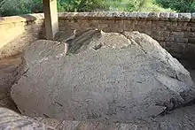 A large boulder with carved inscriptions