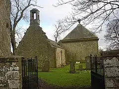 The entrance to the kirkyard, with a side view of the mausoleum