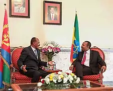 Abiy seated in conversation with Isaias Afwerki