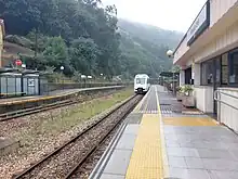 A narrow gauge train at a station in Spain