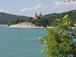 A lake with a church on the far shore