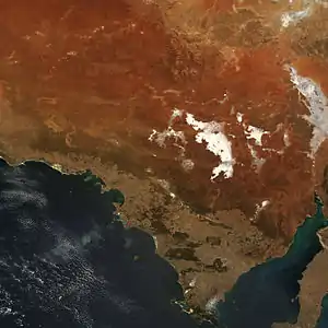 Orange and brown soils mix with off-white saltpans, including Lake Gardiner and Lake Everard in this true-colour image.