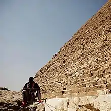 Jay Electronica sits at the foot of a pyramid