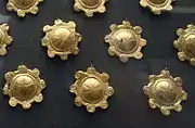 More plaques with convex bosses decorated with rosettes of petals.