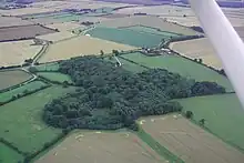 aerialview of woodland. One part of the wood is circular, with a central clearing